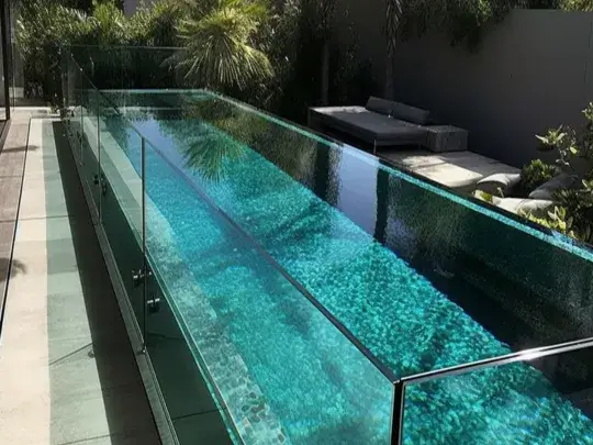 Long backyard pool in Hobart secured with a glass pool fence